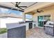 Outdoor kitchen boasts granite countertops, a built-in grill, and a beverage fridge, perfect for entertaining at 493 Talisi Loop, St Cloud, FL 34771