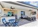 Covered outdoor patio with a TV, lounge area, and a full kitchen, creating an inviting space for outdoor living at 493 Talisi Loop, St Cloud, FL 34771