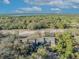 A panoramic aerial of condos surrounded by dense trees, showing proximity to waterway under a blue sky at 5036 Sherwood Ln # 3945-6, Haines City, FL 33844
