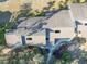 Aerial view of a home featuring an expansive roof, and a stone walkway surrounded by greenery at 5036 Sherwood Ln # 3945-6, Haines City, FL 33844