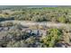 An aerial view of condos surrounded by a heavy tree canopy near parking, waterway and lush foliage at 5036 Sherwood Ln # 3945-6, Haines City, FL 33844