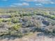 An aerial view showing condos surrounded by dense trees under a clear blue sky with scattered clouds at 5036 Sherwood Ln # 3945-6, Haines City, FL 33844