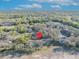 An aerial view showing condos surrounded by dense trees under a clear blue sky with scattered clouds at 5036 Sherwood Ln # 3945-6, Haines City, FL 33844