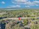A panoramic aerial of condos surrounded by dense trees, showing proximity to waterway under a blue sky at 5036 Sherwood Ln # 3945-6, Haines City, FL 33844