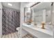 Clean bathroom featuring white tile and a shower with a patterned curtain at 5036 Sherwood Ln # 3945-6, Haines City, FL 33844