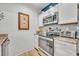 The kitchen features stainless steel appliances, including a microwave and oven at 5036 Sherwood Ln # 3945-6, Haines City, FL 33844