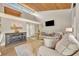 Living room featuring a modern fireplace, wood ceiling, comfortable seating, and a bright atmosphere at 5036 Sherwood Ln # 3945-6, Haines City, FL 33844