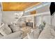 Bright living room featuring a wood-burning ceiling, chandelier, and comfortable seating at 5036 Sherwood Ln # 3945-6, Haines City, FL 33844