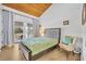 Bright main bedroom with wood ceiling and balcony access with a seating area at 5036 Sherwood Ln # 3945-6, Haines City, FL 33844