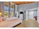 Spacious main bedroom featuring high ceilings, balcony access, and doorway to a full bathroom at 5036 Sherwood Ln # 3945-6, Haines City, FL 33844