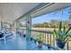 Screened in porch with blue trim, seating and views of the open backyard at 5036 Sherwood Ln # 3945-6, Haines City, FL 33844