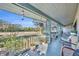 Screened in porch with blue trim, seating and views of the open backyard at 5036 Sherwood Ln # 3945-6, Haines City, FL 33844