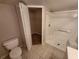 Bathroom featuring a toilet, walk-in shower, and access to a closet at 5064 Park Central Dr # 1731, Orlando, FL 32839