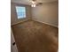 Spacious bedroom with ceiling fan and large window, providing natural light at 5064 Park Central Dr # 1731, Orlando, FL 32839