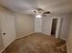 Comfortable bedroom offers neutral walls, carpet flooring, ceiling fan and easy access to the bathroom at 5064 Park Central Dr # 1731, Orlando, FL 32839