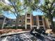 View of the building's exterior with multiple floors, balconies, golf carts, and ample parking space at 5064 Park Central Dr # 1731, Orlando, FL 32839