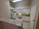 Bright kitchen with white cabinets, appliances, and countertops at 5064 Park Central Dr # 1731, Orlando, FL 32839