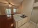Kitchen with white appliances, bar seating, and lots of cabinet space at 5064 Park Central Dr # 1731, Orlando, FL 32839