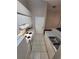 Narrow kitchen with tile floors, white appliances, and plenty of storage at 5064 Park Central Dr # 1731, Orlando, FL 32839