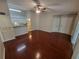 View of living room featuring hardwood floors, a ceiling fan, and access to the balcony at 5064 Park Central Dr # 1731, Orlando, FL 32839