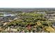 Aerial view of a residential neighborhood showcasing the layout and surrounding landscape with nearby lake at 5108 Legacy Oaks Dr, Orlando, FL 32839