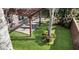 Lush backyard featuring a charming pergola over a paver patio, perfect for outdoor relaxation and entertaining at 5108 Legacy Oaks Dr, Orlando, FL 32839
