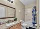 Bathroom features a granite countertop, framed mirror, and shower-tub combo at 5108 Legacy Oaks Dr, Orlando, FL 32839