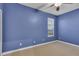 Bedroom with blue walls, carpet flooring, a ceiling fan, and a window at 5108 Legacy Oaks Dr, Orlando, FL 32839