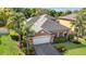 Beautiful home featuring a well-manicured lawn, two-car garage, and an elegant, neutral-toned facade at 5108 Legacy Oaks Dr, Orlando, FL 32839