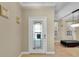 Bright foyer with decorative glass door leading into the home's living spaces at 5108 Legacy Oaks Dr, Orlando, FL 32839