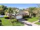 Charming single-story home with a well-manicured lawn, paver driveway, and attached two-car garage at 5108 Legacy Oaks Dr, Orlando, FL 32839