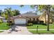 Charming single-story home with a well-manicured lawn, paver driveway, and attached two-car garage at 5108 Legacy Oaks Dr, Orlando, FL 32839
