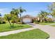 Charming home with a well-manicured lawn, lush landscaping, and a paver driveway at 5108 Legacy Oaks Dr, Orlando, FL 32839