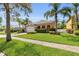 Beautiful home with lush green lawn, mature landscaping, and a brick-paved driveway at 5108 Legacy Oaks Dr, Orlando, FL 32839