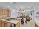 Open floor plan featuring a kitchen with stainless steel appliances and a breakfast bar at 5108 Legacy Oaks Dr, Orlando, FL 32839