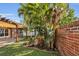 Beautiful backyard with lush tropical landscaping and a brick retaining wall, creating a private oasis at 5108 Legacy Oaks Dr, Orlando, FL 32839