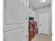 Functional laundry room with modern, red washer and dryer, built-in shelving, and ample storage at 5108 Legacy Oaks Dr, Orlando, FL 32839