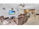 Bright living room with recliner seating, mounted television, and an open floor plan at 5108 Legacy Oaks Dr, Orlando, FL 32839