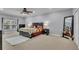 Spacious main bedroom featuring a decorative ceiling fan, plush carpet, and ample natural light at 5108 Legacy Oaks Dr, Orlando, FL 32839
