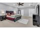Spacious main bedroom with ceiling fan, carpet, and access to ensuite bathroom and closet at 5108 Legacy Oaks Dr, Orlando, FL 32839