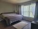 Cozy bedroom with a neutral color palette, plush rug, and large windows for natural light at 5523 Sw 42Nd Pl, Ocala, FL 34474