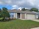 Charming single-story home boasts well-maintained landscaping and an attached two-car garage at 5523 Sw 42Nd Pl, Ocala, FL 34474