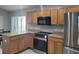 Functional kitchen featuring oak cabinets, stainless steel appliances, and a bright window at 5523 Sw 42Nd Pl, Ocala, FL 34474