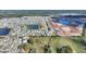 Aerial view of a beautiful home by a pond with plenty of green space and new construction nearby at 5645 Camilla St, St Cloud, FL 34771