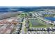Aerial view of a beautiful home by a pond; new development is taking place nearby at 5645 Camilla St, St Cloud, FL 34771