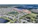 Home aerial view with a serene pond backdrop and new construction nearby at 5645 Camilla St, St Cloud, FL 34771
