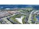Aerial view of a beautiful home by a pond with lots of new homes going up in the area at 5645 Camilla St, St Cloud, FL 34771