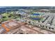 Aerial view of a home in a lakeside neighborhood with a picturesque setting and open land nearby at 5645 Camilla St, St Cloud, FL 34771