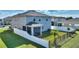 Well-maintained backyard with white fence, a screened-in porch and lush green lawn at 5645 Camilla St, St Cloud, FL 34771
