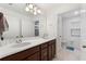 Bathroom with double vanity, wood cabinets, and access to shower and toilet room at 5645 Camilla St, St Cloud, FL 34771